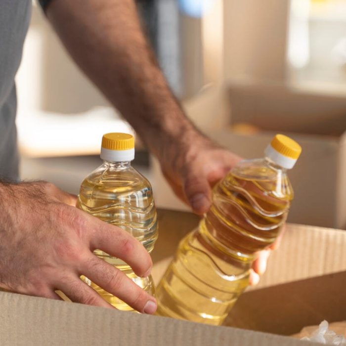 close-up-hands-holding-oil-bottles